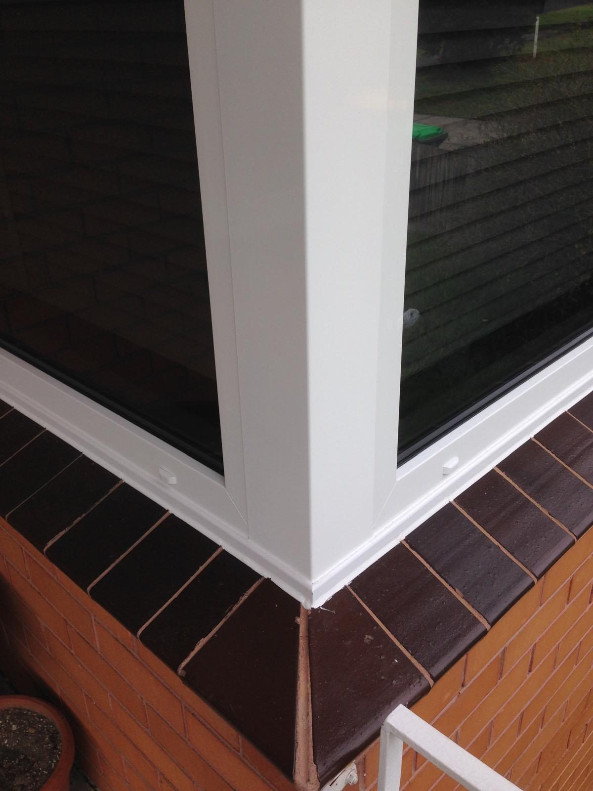 Corner glazing detail above brick sill