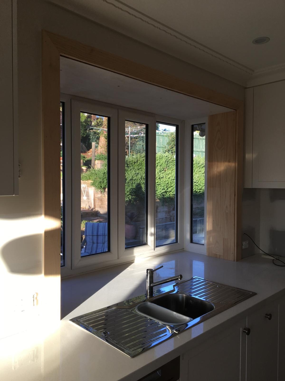 Corner kitchen glazing above a stainless bench