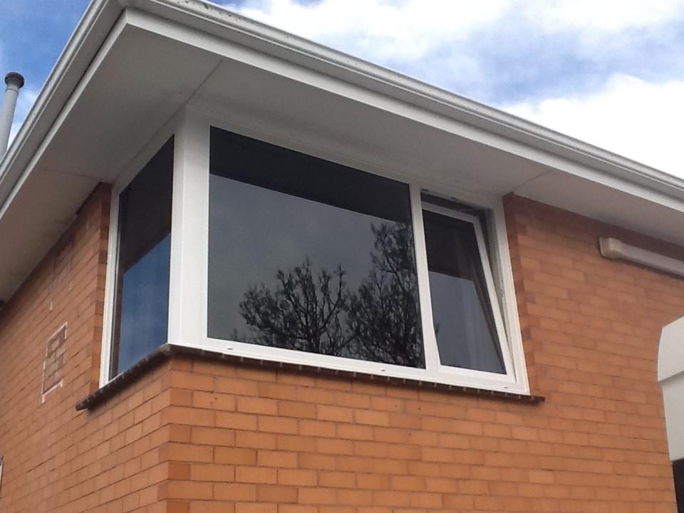 Black framed bay window on brickwork