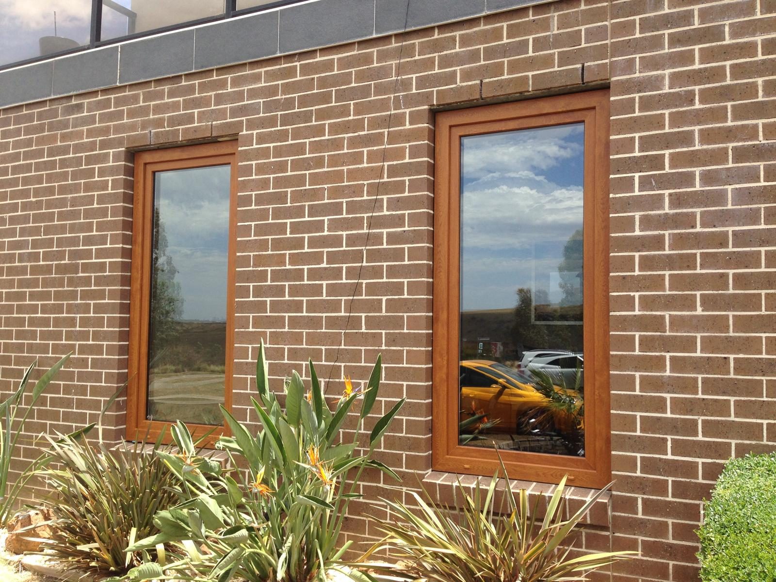 Timber look uPVC windows on a brick home